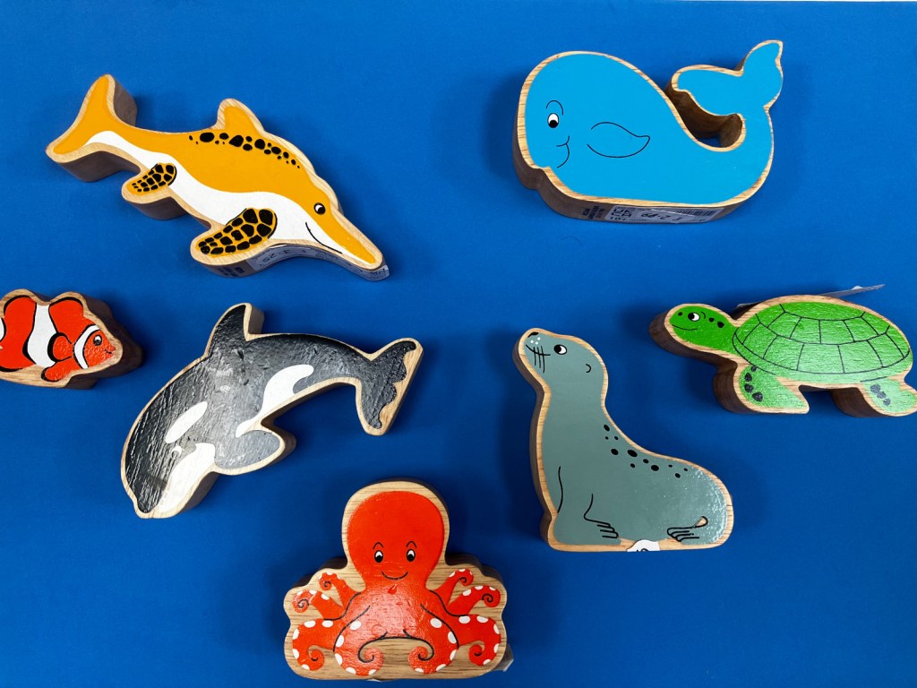Wooden sea creatures including dolphin, whale, octopus and seal